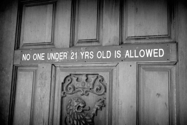 Bar door sign stating No One Under 21 Yrs Old Is Allowed