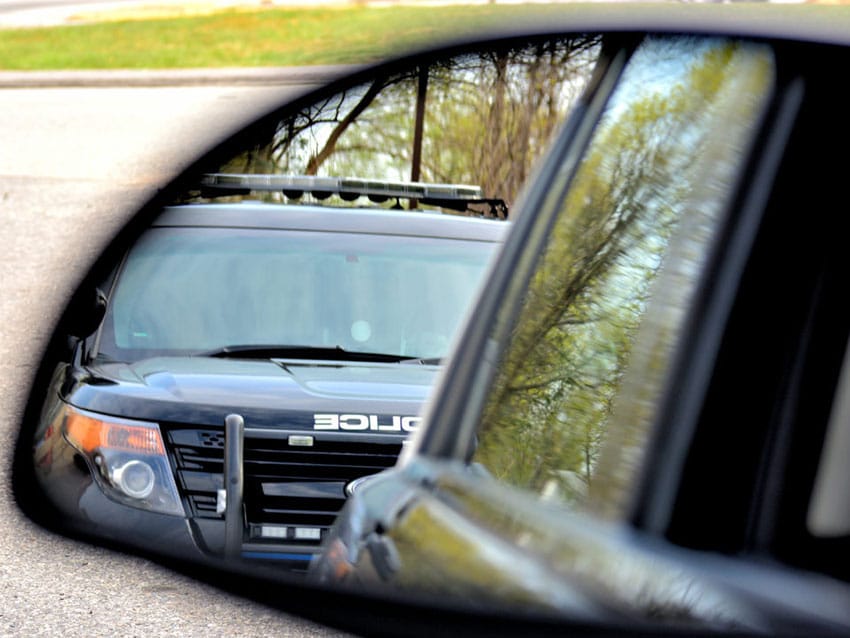Police car in side view mirror