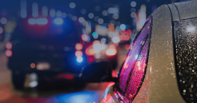 rain soaked car police lights night dwi team