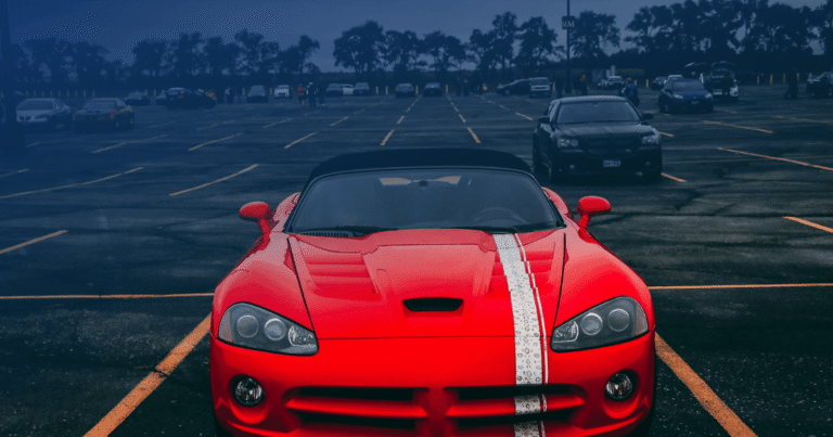 red sports car parked in parking lot dwi team